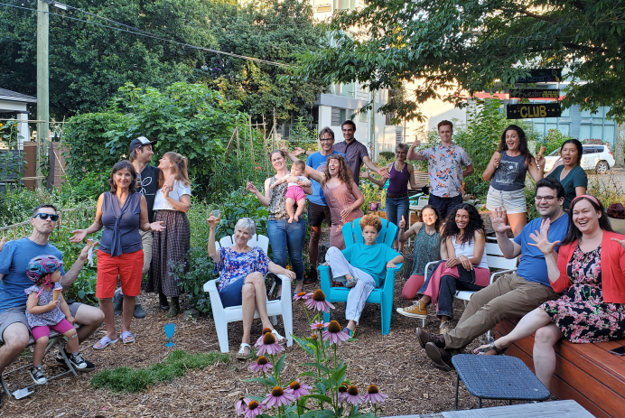 An image of twenty garden stewards gathered outdoors on a summer day